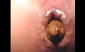 Hot brunette model pooping a yellow shit in close up