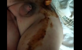 Fat guy holds shit-covered penis over his pussy and ass on a bed
