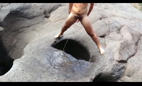 Man Pisses in a Natural Rock Hole