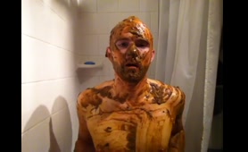 Ginger rubs mud over her tits and belly in the bathroom