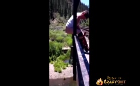 Man Pisses and Shits Off a Bridge