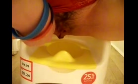 Blonde Babe Pisses into Ice Cream Container in Bathroom