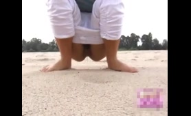 Sexy Lady Pees on the Beach