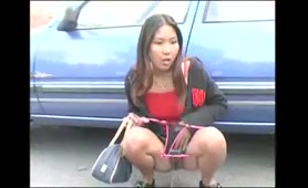 Asian Babe Pisses in Parking Lot